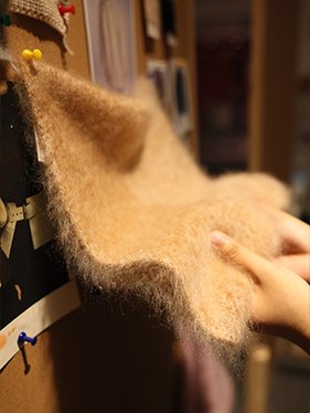 Custom embroidery, beading, and lace embellishments for designer knitwear